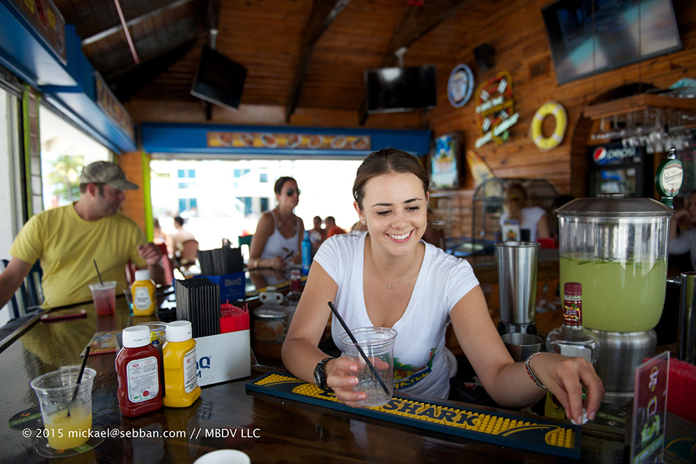 Pascal, the manager of Castle Beach Club Tiki Bar in Miami Beach, confidently overseeing the bar operations.
